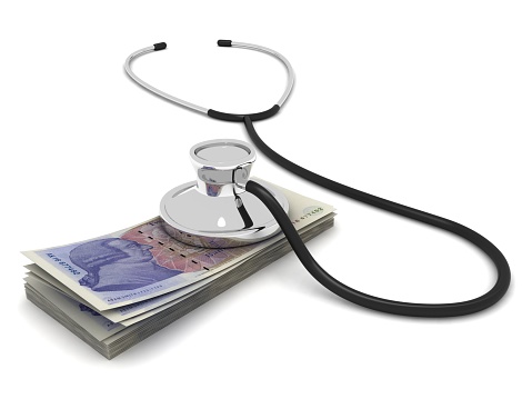 UK pound money investment loan analysis stethoscope