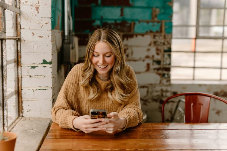 Borrower checking a loan account on a smartphone: After the Loan Is Approved, Borrowers Still Deserve Real Support