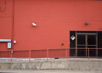 Security camera and rear entrance on a commercial building: Crime Risk for UK Firms: Why Nearly a Third Could Be Victims This Year