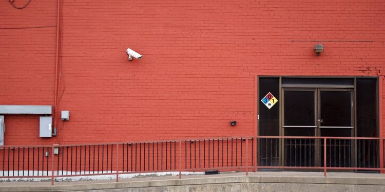 Security camera and rear entrance on a commercial building: Crime Risk for UK Firms: Why Nearly a Third Could Be Victims This Year