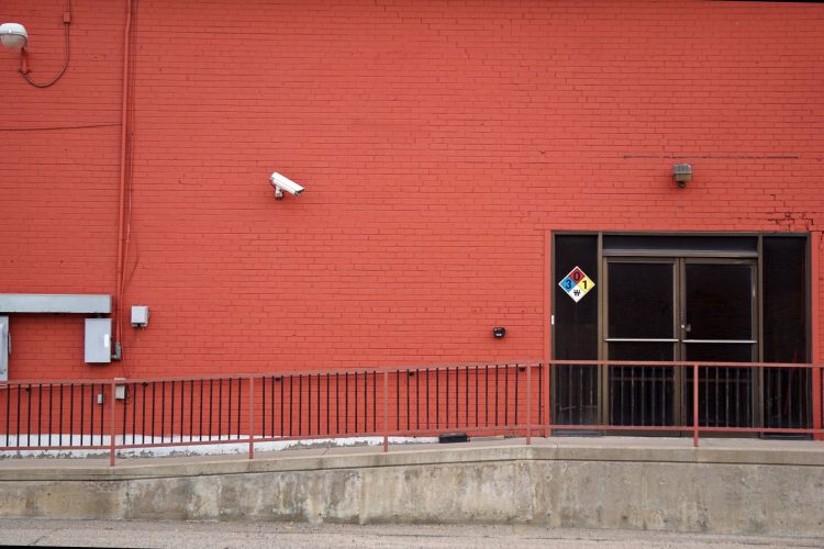 Security camera and rear entrance on a commercial building: Crime Risk for UK Firms: Why Nearly a Third Could Be Victims This Year