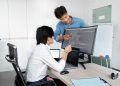 Engineers reviewing code on a monitor: Public-Record API Due Diligence: What Comes Before the Build