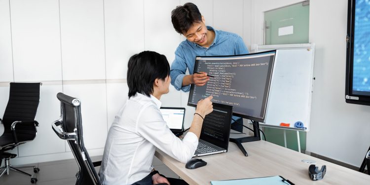 Engineers reviewing code on a monitor: Public-Record API Due Diligence: What Comes Before the Build