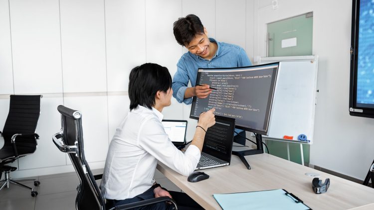 Engineers reviewing code on a monitor: Public-Record API Due Diligence: What Comes Before the Build