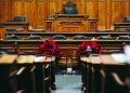 An empty wood-panelled courtroom ahead of a hearing, illustrating cross-Border Business Disputes Demand Tailored Strategies and Experienced Counsel