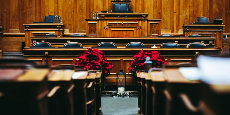 An empty wood-panelled courtroom ahead of a hearing, illustrating cross-Border Business Disputes Demand Tailored Strategies and Experienced Counsel