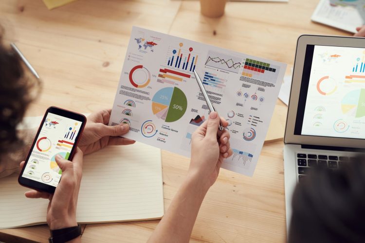 Evaluating Agency Expertise Starts With Their Results in Your Own Industry: marketing specialists reviewing SEO and campaign analytics charts at a desk