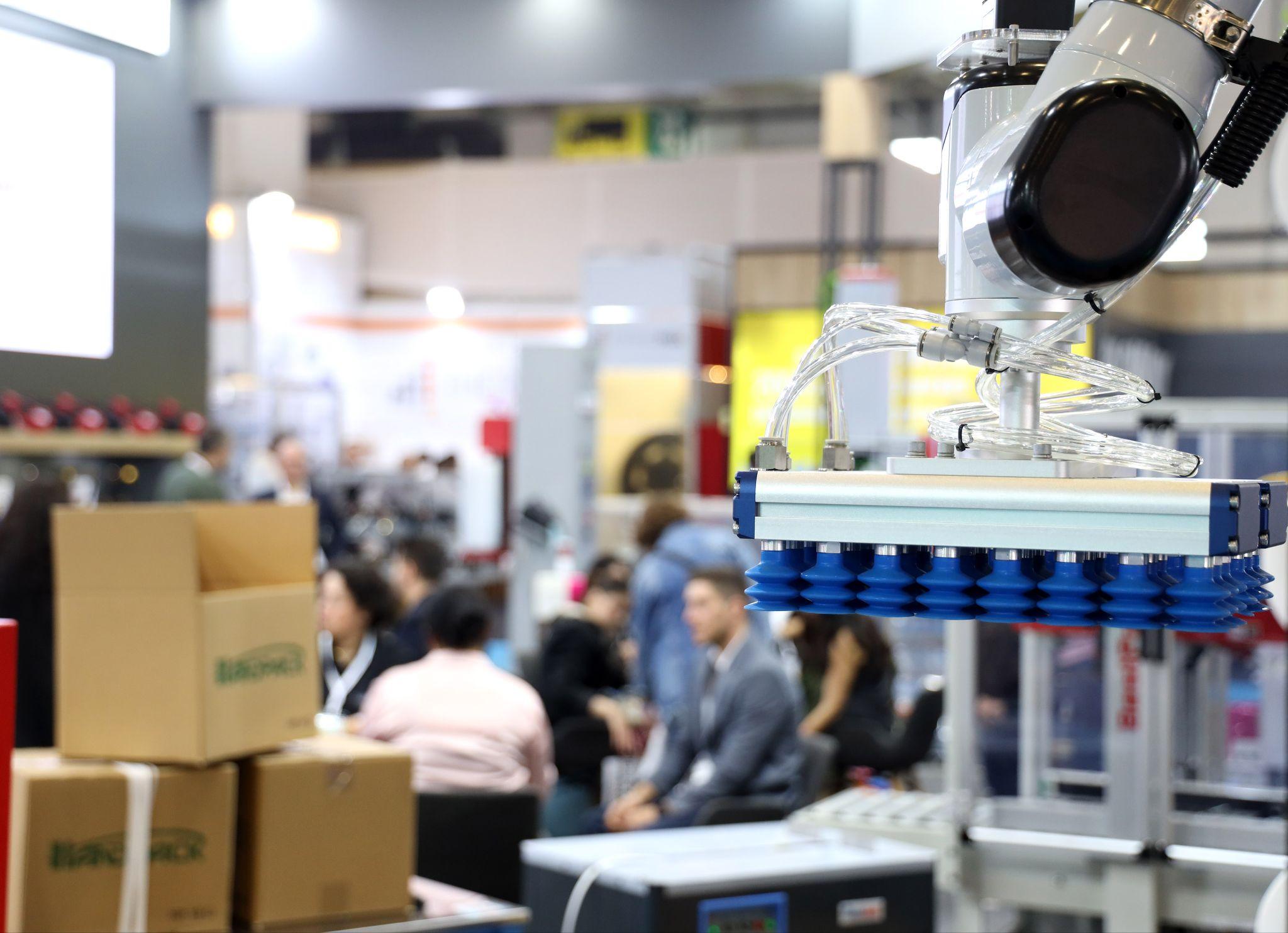 Sustainability and automation take centre stage at Eurasia Packaging Istanbul 2026: a robotic vacuum gripper lifting cartons on an exhibitor stand at Eurasia Packaging Istanbul